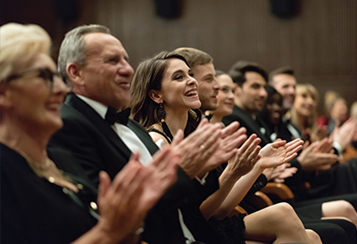 Care for Cultural Events A formally dressed crowd applaud