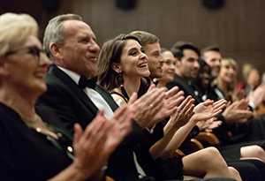 Home Care Entertainment A formally dressed crowd applaud