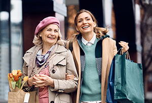 Home care appointments A younger carer accompanies person in need of assistance.