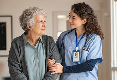 Palliative Care Carer assists senior woman